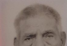 Olegario Thijzen A picture containing necktie, person, person, wall Description automatically generated