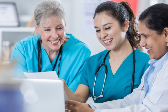 Female medical team discuss patient diagnoses