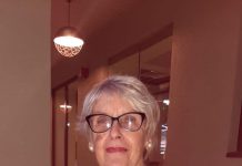 Edith Henriquez-Arends A person wearing glasses and a striped shirt AI-generated content may be incorrect.