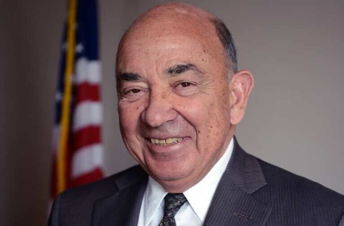 Portrait of Judge Alvin Hellerstein in formal attire with U.S. flag background